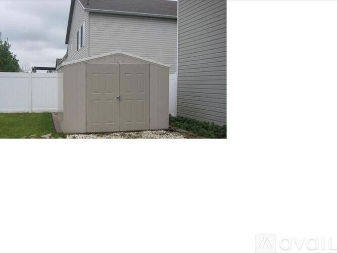 A gray garage door is closed and has a lock on it.