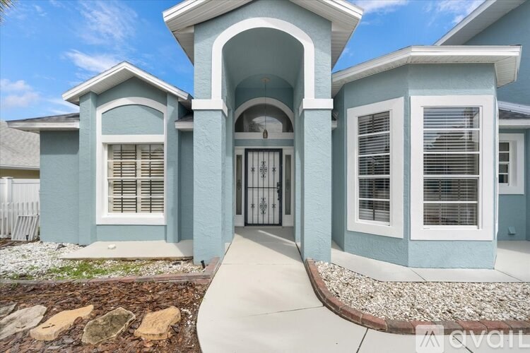 A house with a blue exterior and a white door.