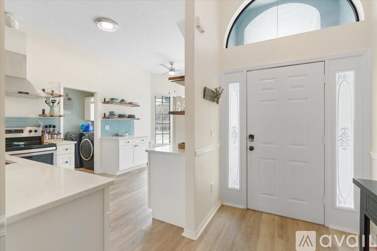 A kitchen with white cabinets and a large island.
