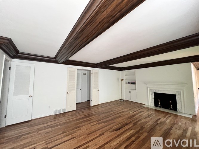 A room with wooden floors and a fireplace.