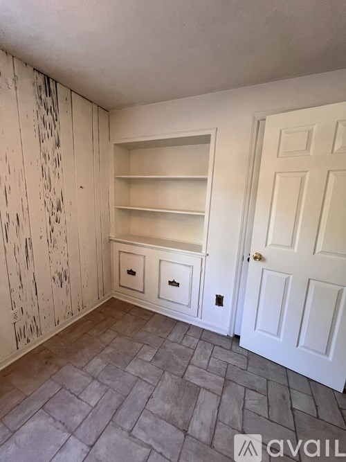 A room with a door and a cabinet.