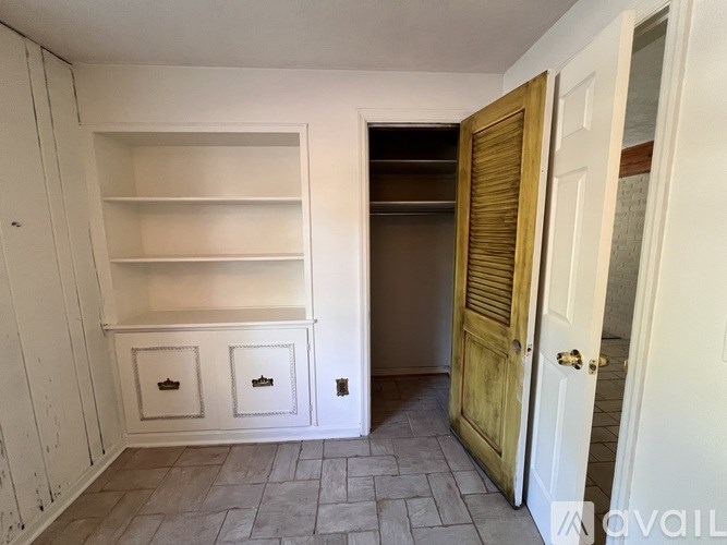 A room with a white door and a wooden cabinet.