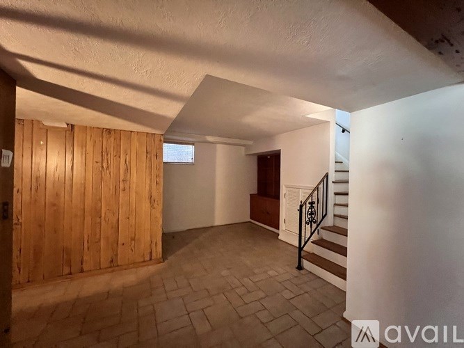 A room with wooden walls and a tiled floor.