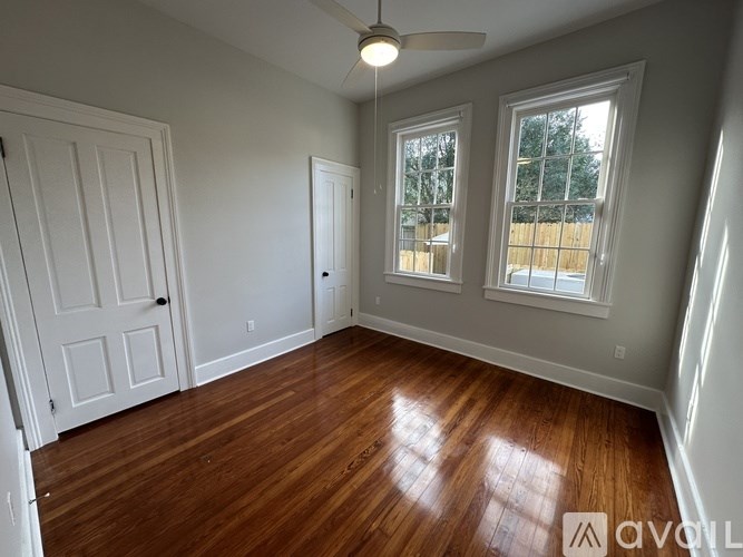 A room with wooden floors and white walls.