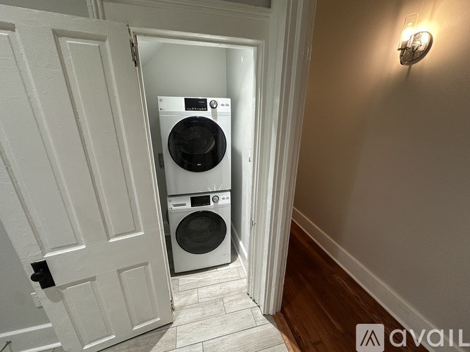 A washing machine is placed in a small room.