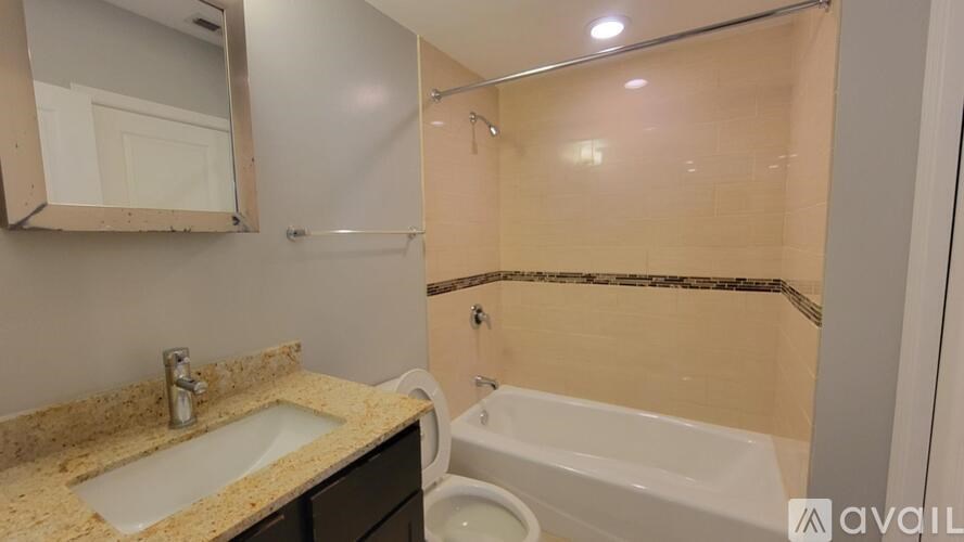 A bathroom with a sink, toilet, and bathtub.