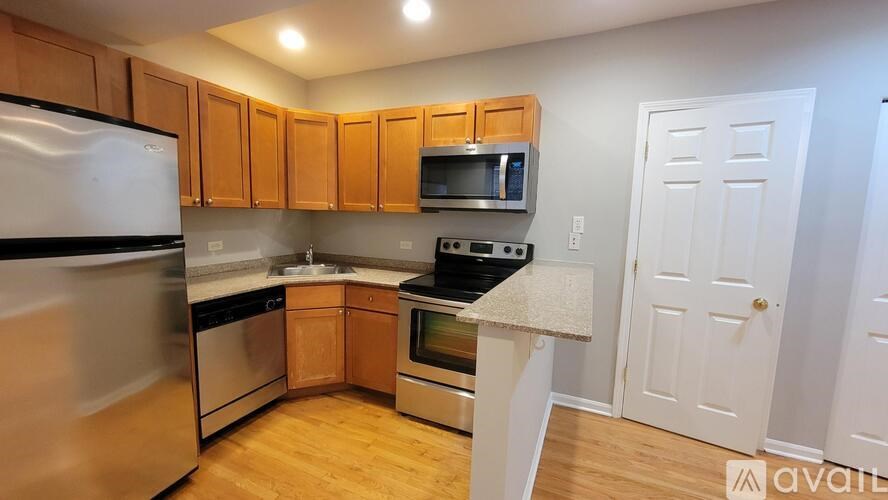 A kitchen with wooden cabinets and stainless steel appliances.