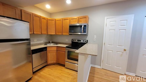 A kitchen with wooden cabinets and stainless steel appliances.
