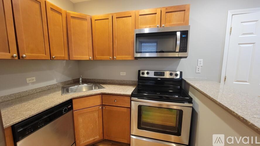 A kitchen with wooden cabinets and a stove top oven.