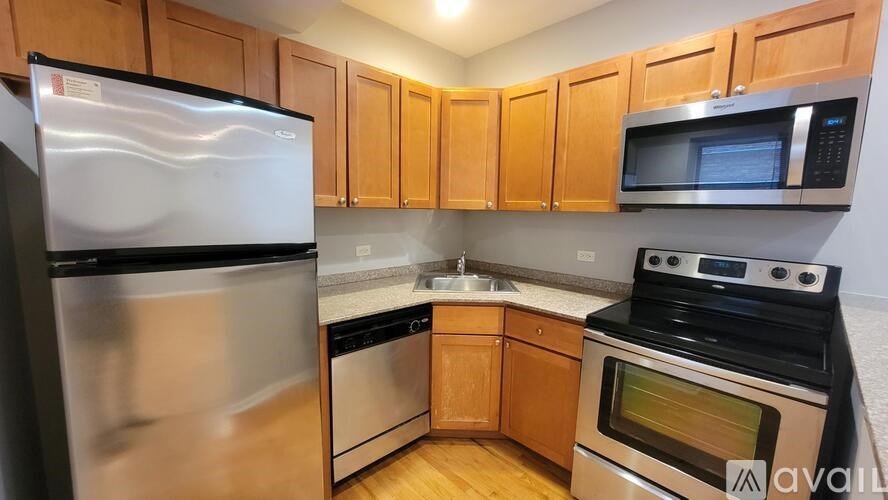 A kitchen with wooden cabinets and stainless steel appliances.