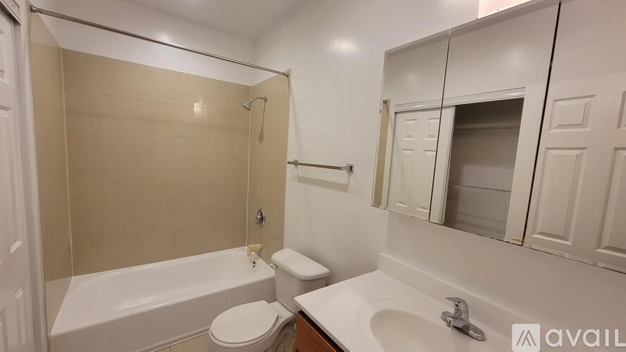 A bathroom with a toilet, sink, and bathtub.