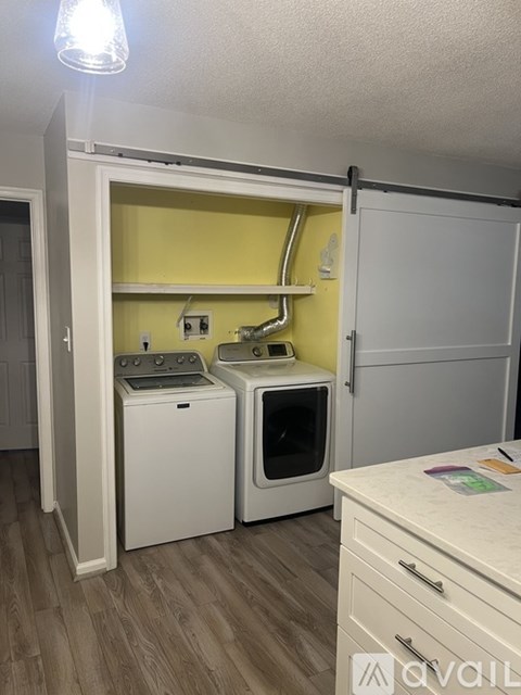 A small kitchen with a white oven and microwave.