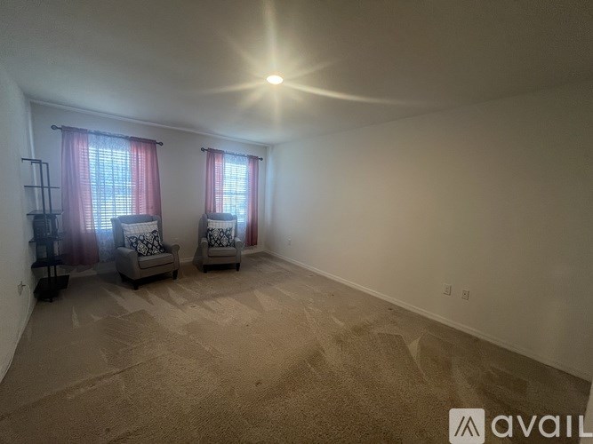 A room with two chairs and a carpeted floor.