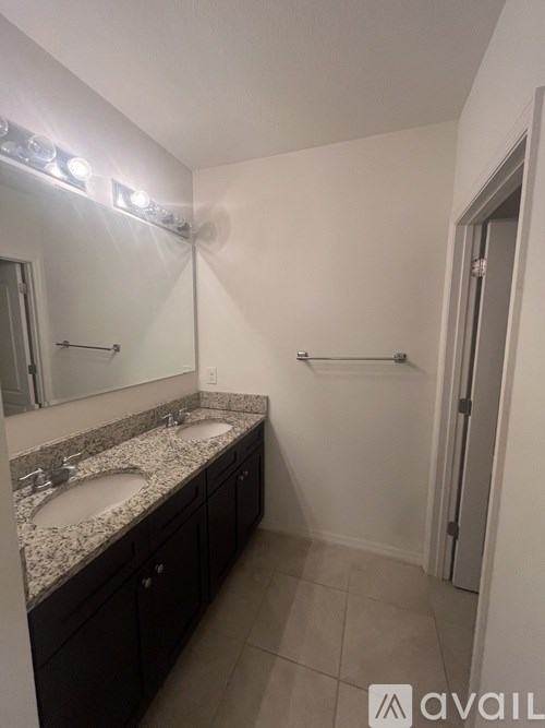 A bathroom with a sink and mirror.