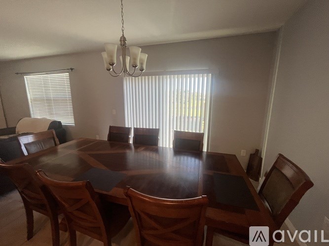 A dining room with a wooden table and chairs.