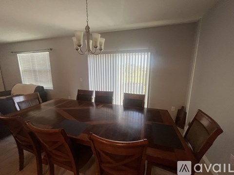 A dining room with a wooden table and chairs.