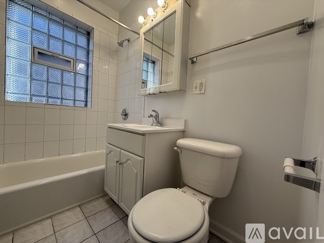 A bathroom with a toilet, sink, and bathtub.