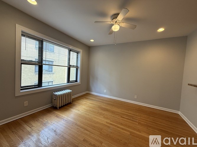 A room with wooden floors and a ceiling fan.