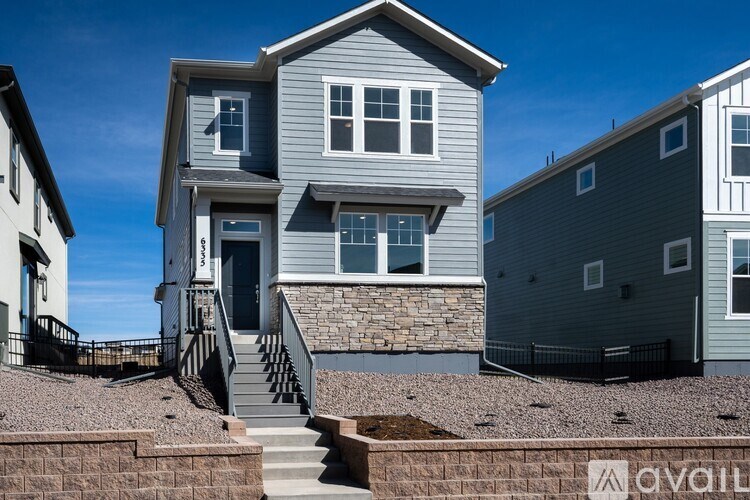 A house with a grey exterior is available for purchase.