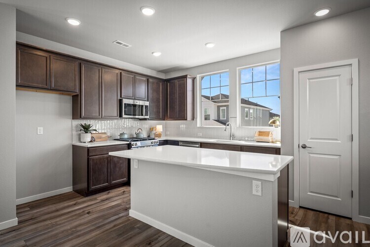 A kitchen with brown cabinets and a white countertop.