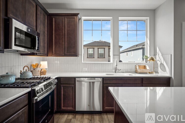 A kitchen with dark wood cabinets and a white countertop.