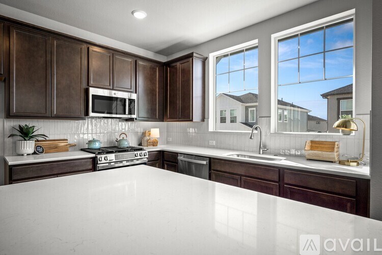 A kitchen with brown cabinets and a white countertop.