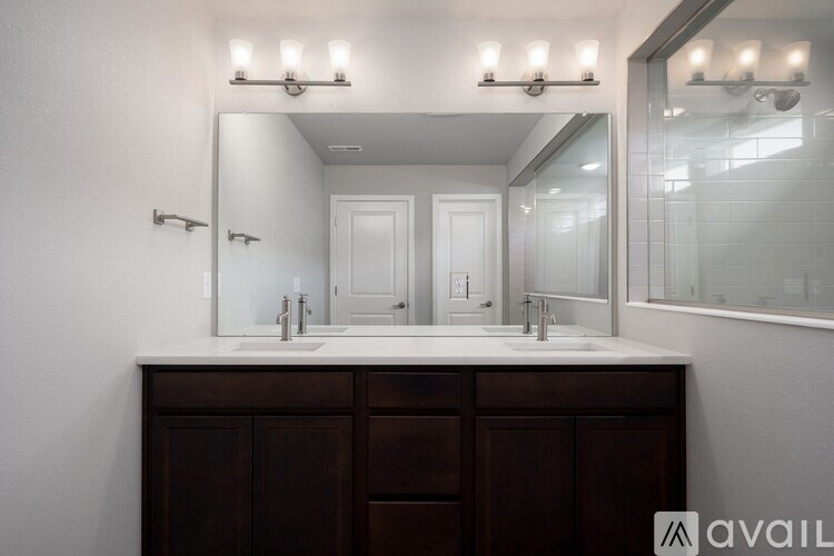 A bathroom with a vanity and a mirror above it.