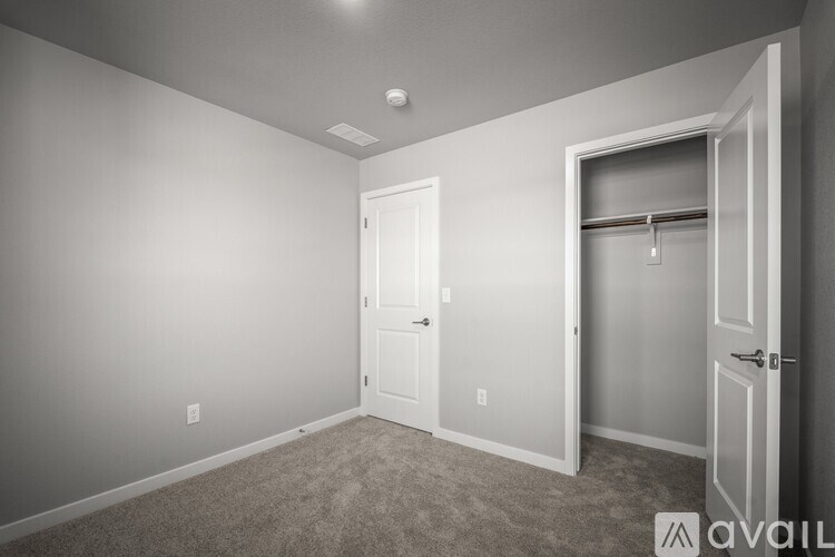 A room with two doors and a carpeted floor.