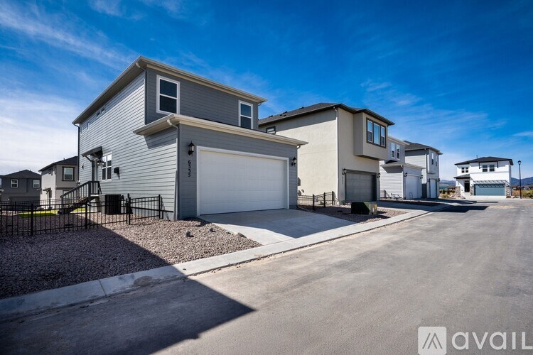 A row of houses with a clear blue sky above them.