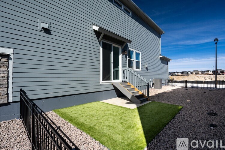 A house with a grey exterior and a black railing.