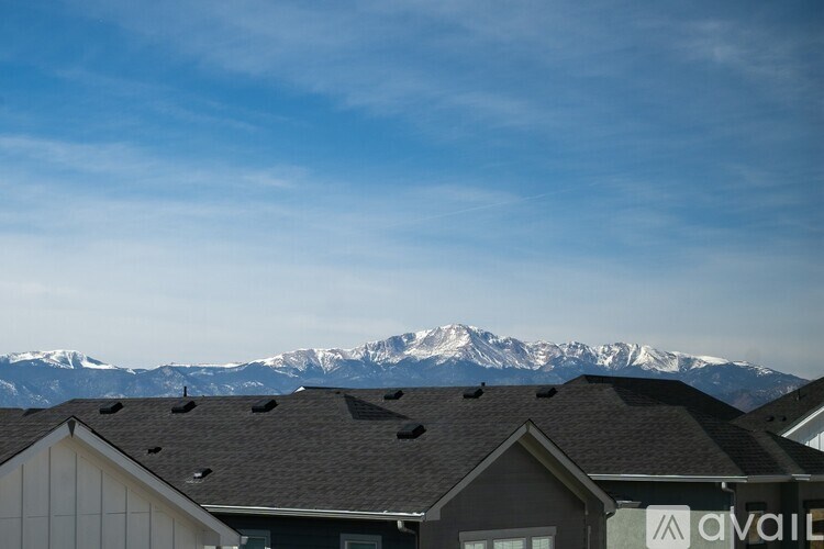 A mountain range is in the background of a suburban neighborhood.