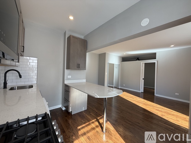 A modern kitchen with a stove top oven and a table.