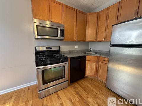 A kitchen with wooden cabinets and stainless steel appliances.
