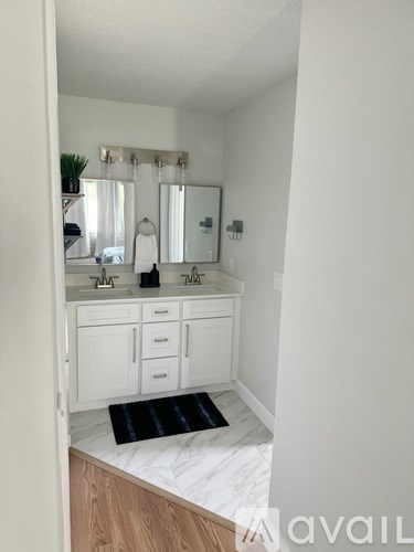 A bathroom with a vanity and a mirror.