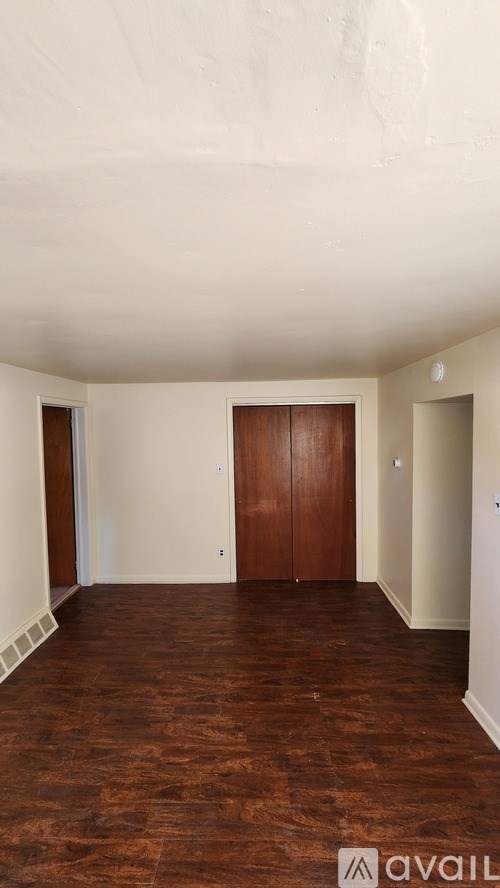 A room with wooden floors and white walls.