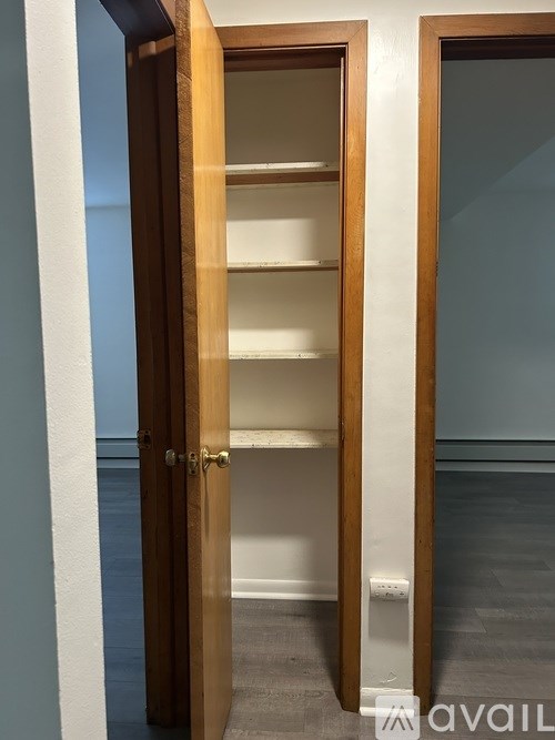 A wooden door with glass panels is open.