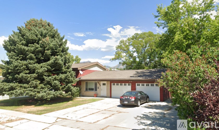 A house with a car parked in front of it.