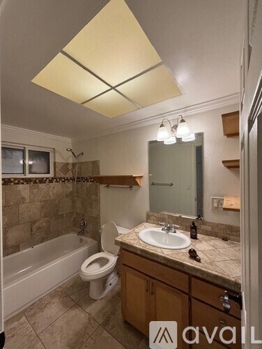 A bathroom with a toilet, sink, and bathtub.