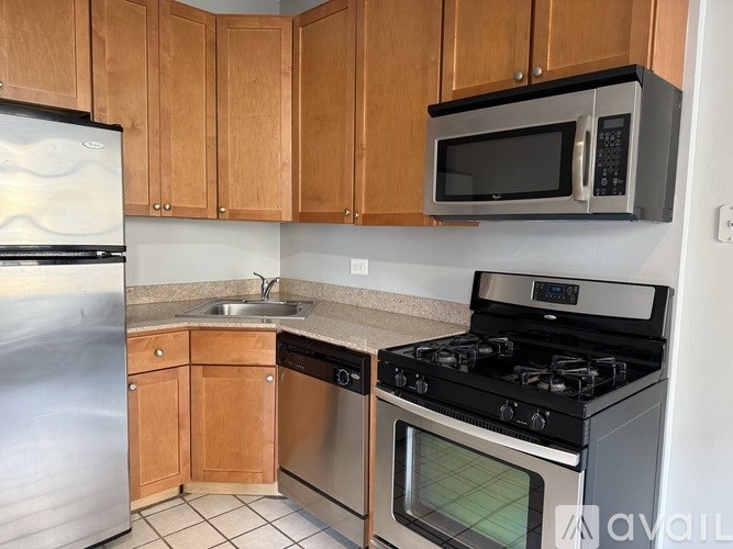 A kitchen with wooden cabinets and a black stove top oven.