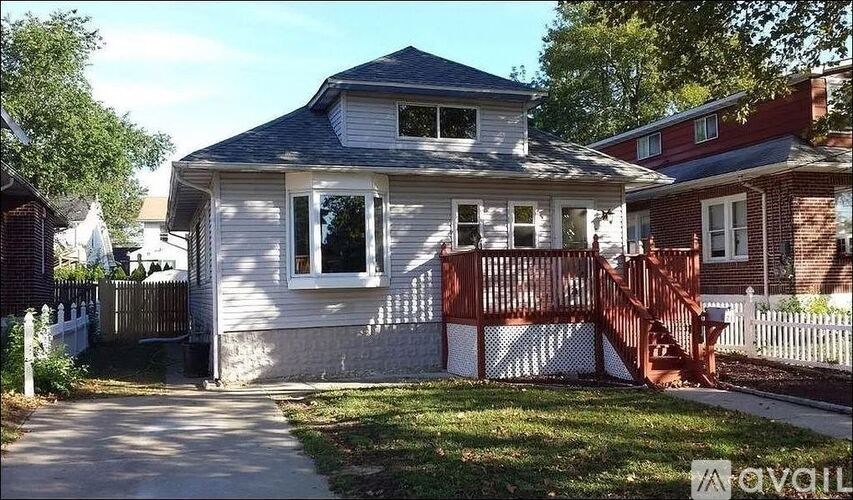 A house with a white exterior and a brown fence.
