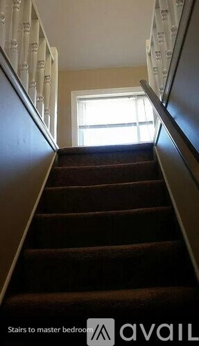 A staircase leading to a master bedroom.