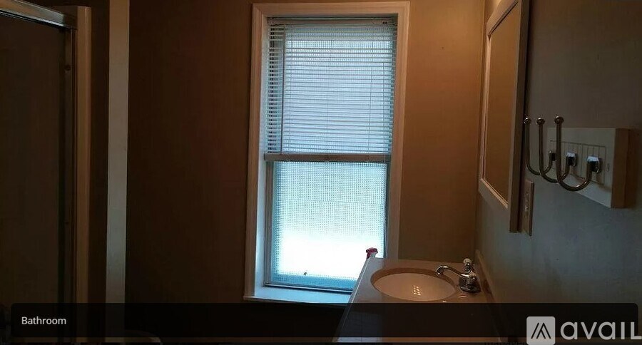 A bathroom with a sink and a window.