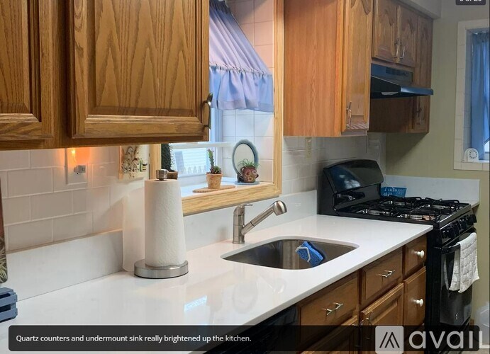 A kitchen with wooden cabinets and a white countertop.