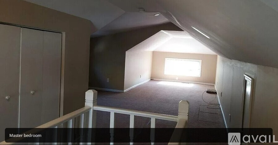 A room with a window and a door labeled as the master bedroom.