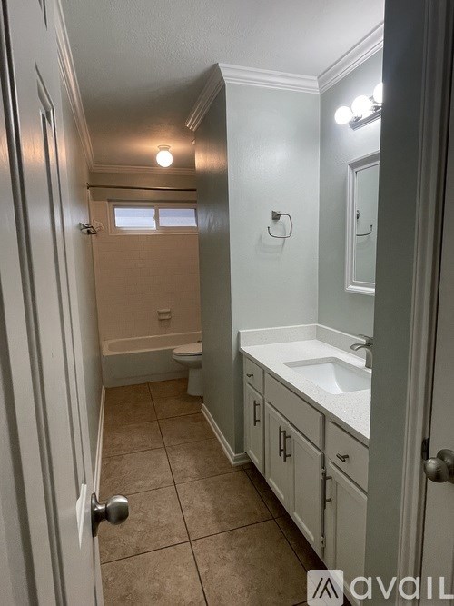 A bathroom with a white sink and a white door.