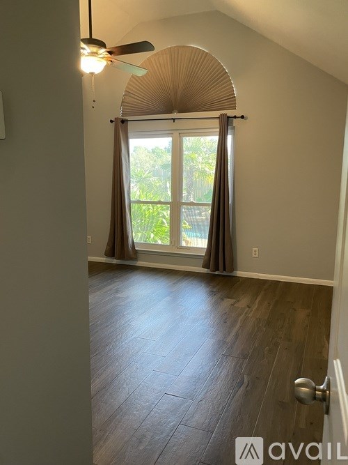 A room with a fan and a door.