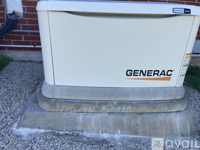 A Generac branded generator sits on a concrete slab.