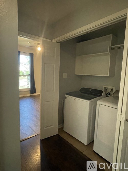 A small laundry room with a washer and dryer.