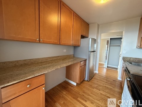 A kitchen with wooden cabinets and a granite countertop.