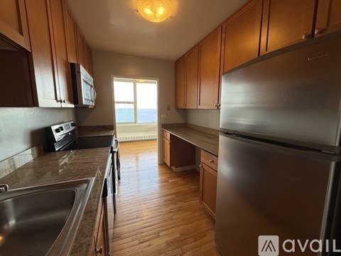 A kitchen with wooden cabinets and stainless steel appliances.